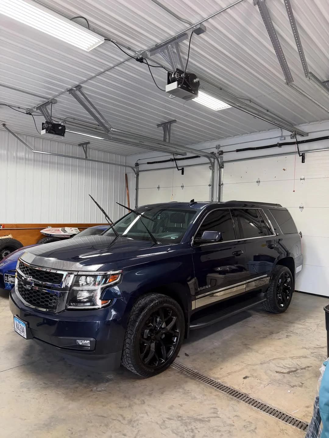 Deep-blue Chevrolet Tahoe after wash and wax work
